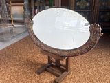a mirror sitting on a stand in a room