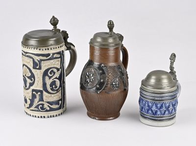 three different types of beer mugs sitting next to each other on a white surface