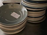 several plates stacked on top of each other on a kitchen counter