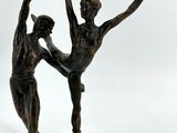 bronze statue of a couple of dancers on a white background