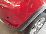 a close up of a red car that has been dented