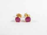 une paire de boucles d'oreilles à clous ornées de pierres roses sur fond blanc