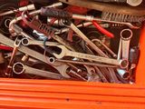 many wrenches in a tool box on the floor