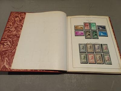 an open book with stamps on it sitting on a table