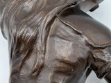 statue of a woman laying on her back on a white surface