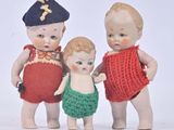 three little dolls that are standing next to each other