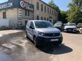 a van parked in front of a building with cars parked in front of it