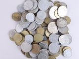 a pile of silver and gold coins on a white surface