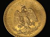 two gold coins with the image of an eagle on them