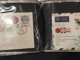 two envelopes with stamps on them are sitting on a table