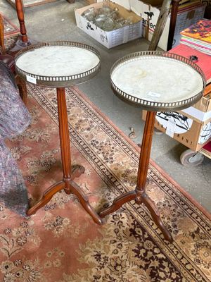 two tables that are sitting on a rug in a room