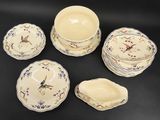 six pieces of porcelain dinnerware including a bowl, plate, and bowl
