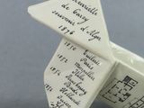 a white origami with writing on it sitting on a table