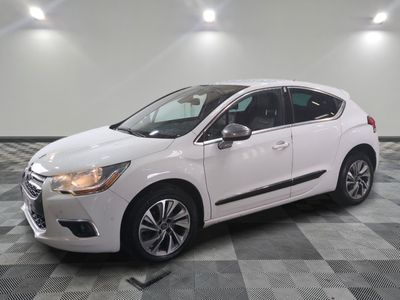 the white car is parked on a checkered floor in the garage