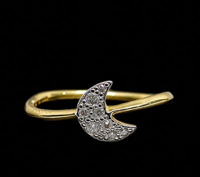 a close up of a gold ring with a crescent shaped diamond