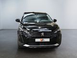 the front view of a black car parked in a showroom