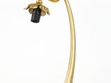 brass table lamp with a black shade and a gold metal base