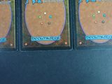 three cards are sitting on top of each other on a table