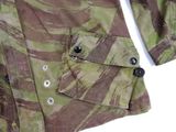 a close up of a camouflage shirt with buttons on it