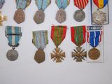 many medals and medals displayed on a white surface