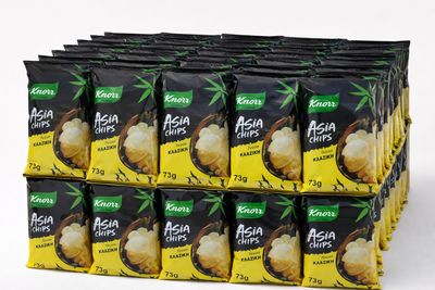 a stack of bags of asian chips on a white surface