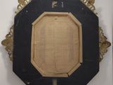 a picture of a black and gold frame hanging on the wall