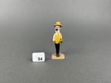 a close up of a figurine of a man with a hat and yellow vest
