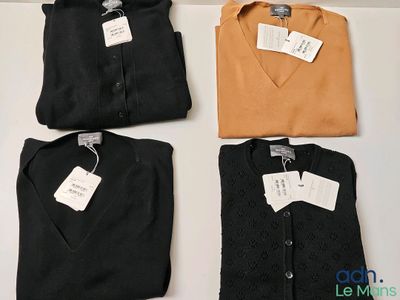 trois chemises avec leurs étiquettes, posées sur une table