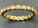 a close up of a gold ring with diamonds on it