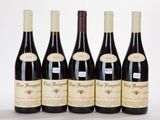 six bottles of red wine are lined up in a row