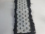 a close up of a black and white rug on a table
