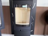 a black stove sitting next to a wall with a sign on it