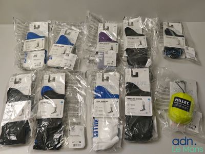 many pairs of men ' s socks and a tennis ball on the table