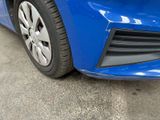 a close up of a blue car ' s front bumper