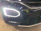 a close up of a car ' s headlight and front bumper
