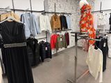 a lot of clothes that are on display in a store