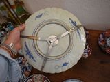 a person holding a plate with a clock on it