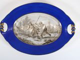 a blue plate with a picture of a man on horseback