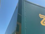 a green semi truck with a yellow z logo on the side
