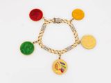 a close up of a bracelet with coins and charms on it