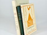 two books are stacked on top of each other on a white surface