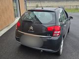 a black car parked in front of a building