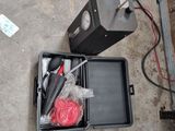 une boîte à outils posée par terre à côté d'une boîte de câbles