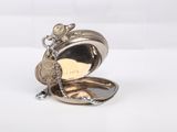 a silver pocket watch with a chain hanging from it