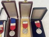several medals and medals are arranged in a row on a white surface