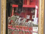 a gold framed mirror on the wall of a restaurant