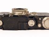 a black camera that is sitting on a white surface