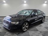 the black audi sedan is parked in a large room