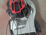 a lawn mower that is sitting on the ground