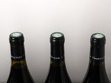 four bottles of wine are lined up on a table
